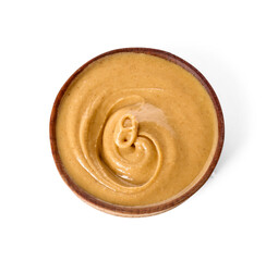 Bowl with tasty peanut butter on white background