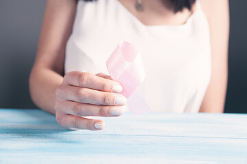 female hands holding a pink ribbon