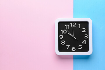Stylish clock on color background