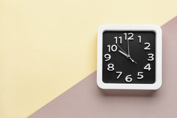 Stylish clock on color background