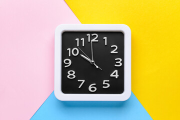 Stylish clock on color background