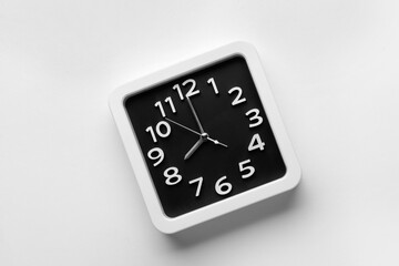 Stylish clock on light background