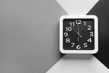 Stylish clock on color background