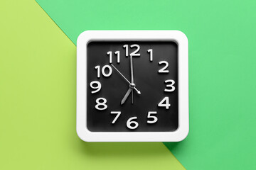 Stylish clock on color background