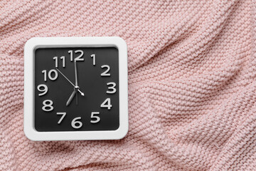 Stylish clock on fabric background