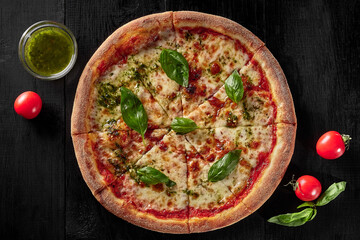 Top view of pizza margherita with tomatoes, mozzarella, basil