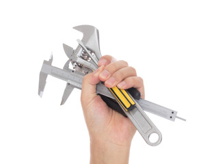 Hands holding various tools in front of white background