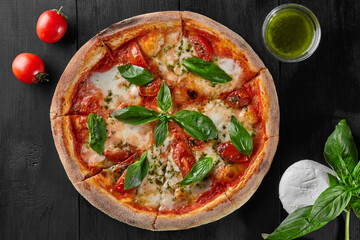Obraz na płótnie Canvas Pizza Margherita with tomatoes, mozzarella cheese and basil
