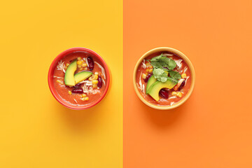 Bowls of tasty chicken enchilada soup on color background