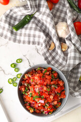 Bowl of tasty Pico de Gallo salsa on table