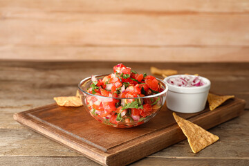 Bowl of tasty Pico de Gallo salsa on table