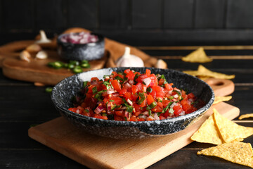 Bowl of tasty Pico de Gallo salsa on table