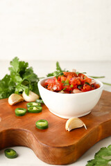 Bowl of tasty Pico de Gallo salsa on table
