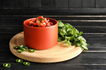 Bowl of tasty Pico de Gallo salsa on table