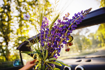 Closeup of driving in cabriolet car on sunny summer day. Couple traveling or having romantic date...