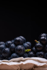 large grapes on a cloth on a black background.
A variety called Nagano Purple