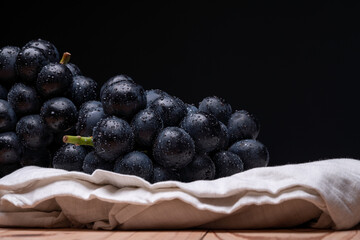 large grapes on a cloth on a black background.
A variety called Nagano Purple