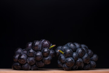Large Grapes On A Board On A Black Background.
A variety called Nagano Purple
