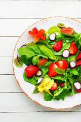 Summer salad with berries and herbs