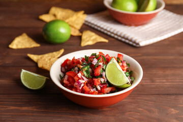 Bowl of tasty Pico de Gallo salsa on table