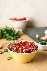 Bowl of tasty Pico de Gallo salsa on table