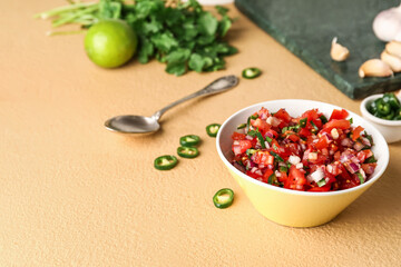 Bowl of tasty Pico de Gallo salsa on color background