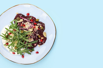 Plate with delicious beetroot carpaccio on color background