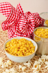 Tasty corn with popcorn and bundle bag on color background. Festa Junina (June Festival) celebration