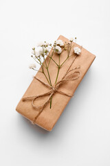 Gift box and beautiful gypsophila flowers on white background
