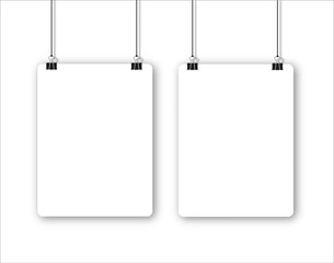 Blank poster hanging on a binder clips. A4 white paper sheet hangs on a rope with clips.