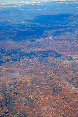 Fototapeta na wymiar mountain landscape view from airplane window, vertical top view.