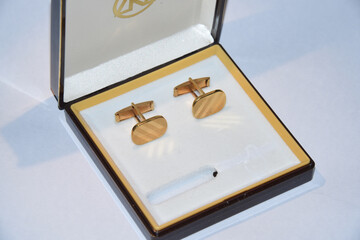 Golden blazer buttons in a box on the table