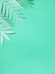 Summer background with colorful paper tropical leaves.