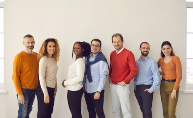 Diversity people group team union concept. Smiling casual men and women group different age and nationality posing for camera showing positive friendly expression. Full body portrait