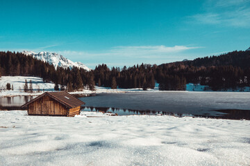 A wooden cabin in front of a mountain