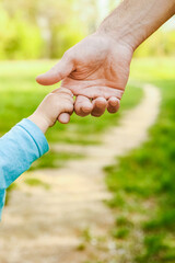 the parent holding the child's hand with a happy background