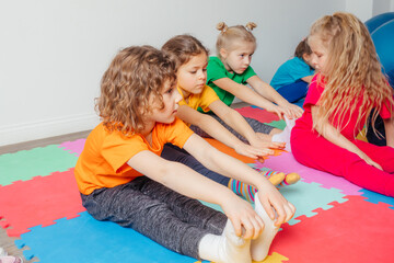 Curious preschool boy enjoying group gymnastic training