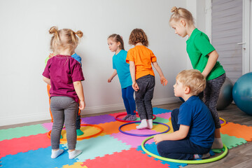 Sport activities with hula hoops at kindergarten