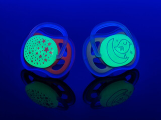 Glow in the dark, pink and blue pacifiers for toddlers. Easy to find during night time.