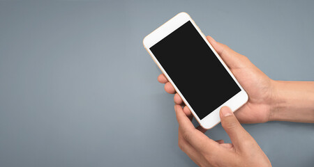 Hand holding smartphone device touching screen