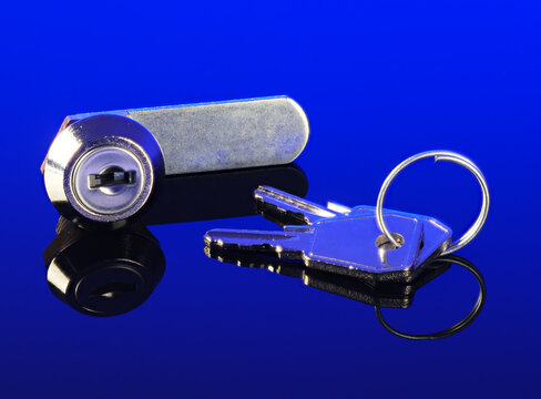 Letterbox locking cylinder and keys on dark blue backbround