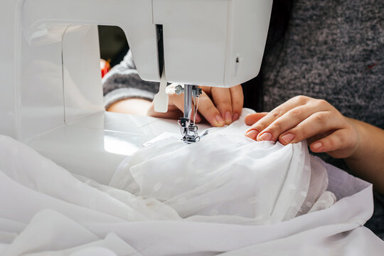 Wedding dressmaker altering white vintage wedding dress