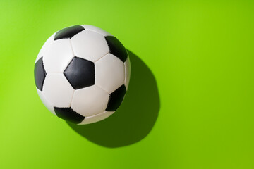 top view of soccer ball on green background, concept football time