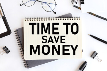 time to save money. text on notepad. on a white background near the stationery