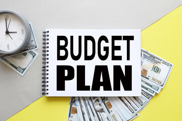 Budget plan. background with money, dollar bills and yellow background. text on notepad