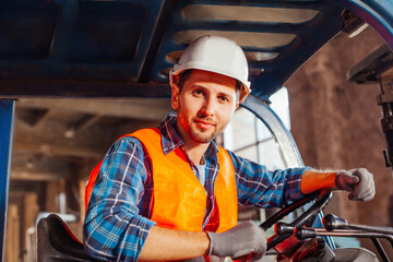 Young confident warehouse worker posing in a forklift truck © oksix