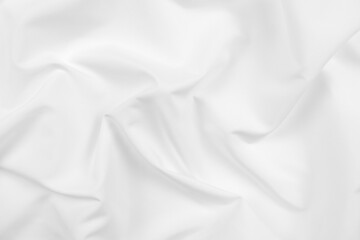 Abstract white fabric texture background. Cloth soft wave. Creases of satin, silk, and cotton.