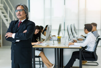 Senior business man, office staffs background.