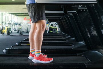 Close up shoe and legs. Asian men running in a gym on a treadmill.
