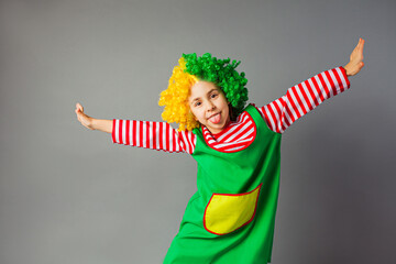 The funny little girl in a clown uniform